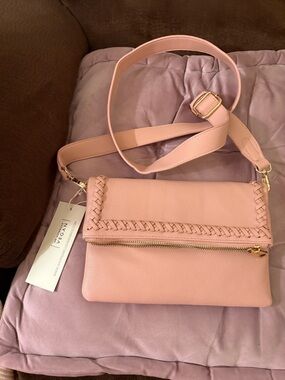 Crossbody Bag by Isabelle . Front and back snap pocket with polka dots lining.